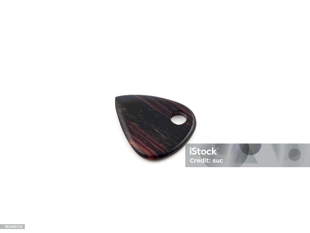 Guitar plectrum Homemade wooden guitar plectrum. Abstract Stock Photo