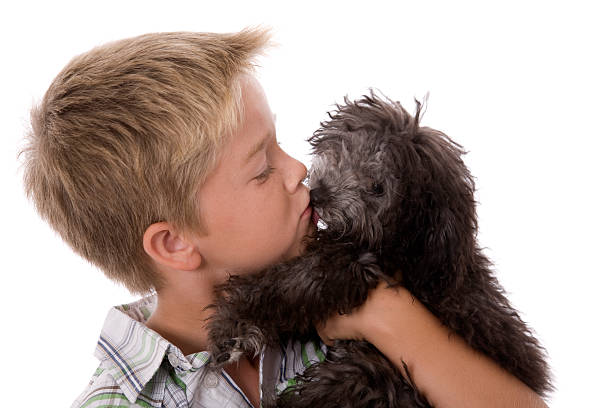 istock Boy Kissing Puppy 182686328