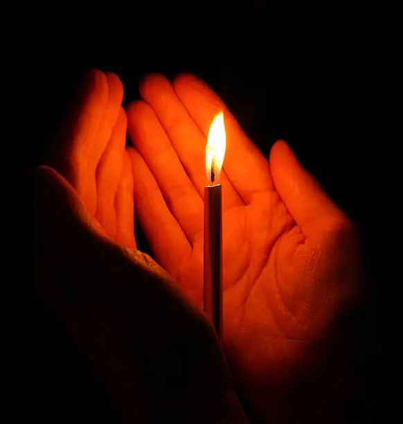 Photo of candle in hands