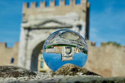 Crystal ball against Roman arch