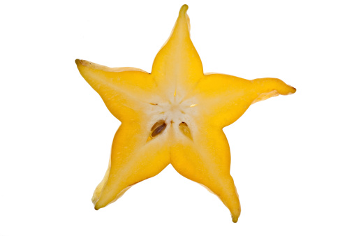 A single slice of star fruit on a white background.