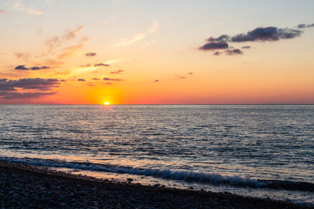 istock view of sun setting over horizon from pebble beach 1826874217