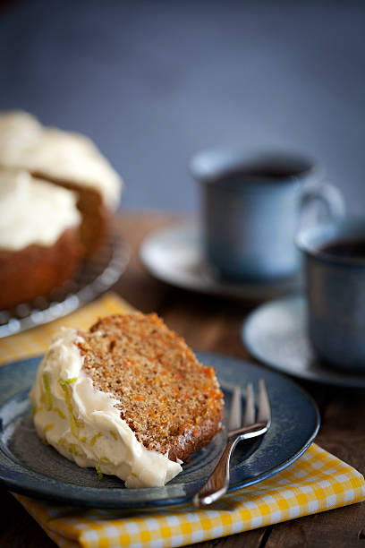 Slice of carrot cake served with coffee in blue plate ware stock photo