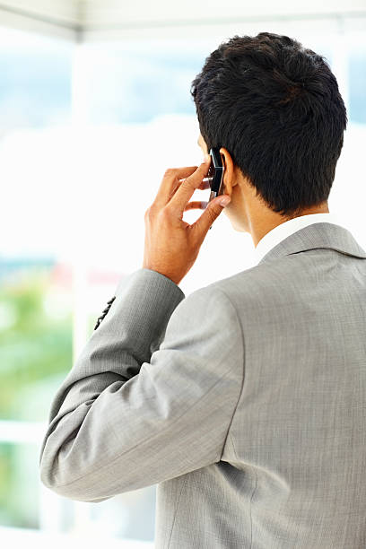 istock Back view of a businessman talking on cellphone 182688378