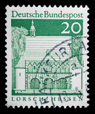 A German postage stamp depicting the town of Lorsch in Hesse.  Shot in studio on black background and converted from RAW file with 16 bit processing.