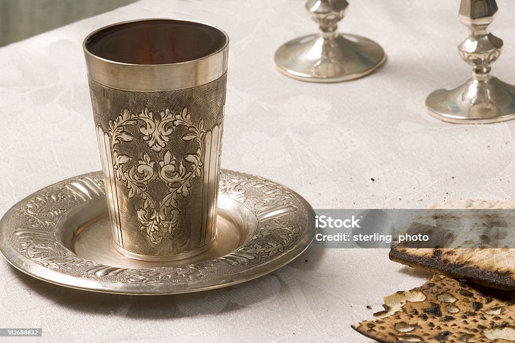after the seuda "what remains on the table at the end of a festive passover meal: silver goblet with wine, candlesticks, scraps of matza and crumbsSee more of my pesach images" Bread Stock Photo