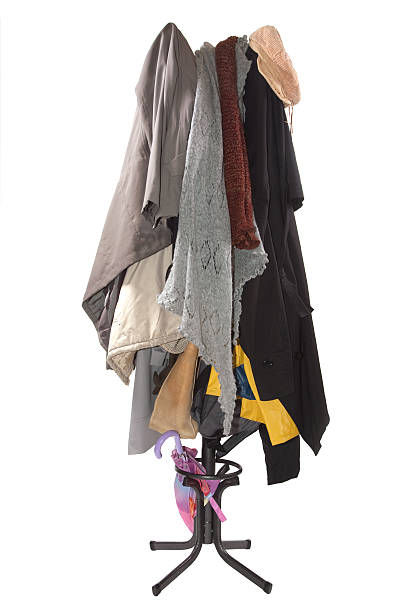 Coat rack with lots of overcoats "Many overcoats, hats and neckwear hanging on a coat rack isolated on white." coat hook photos stock pictures, royalty-free photos & images