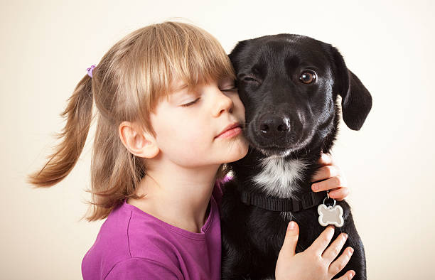 istock Girl snuggling with her dog 182689354