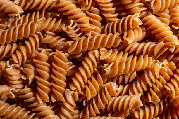 istock Uncooked Whole Grain Fusilli Pasta Background 1826893586