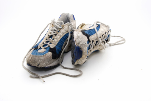 Pair of yellow classic old school sneakers on white background