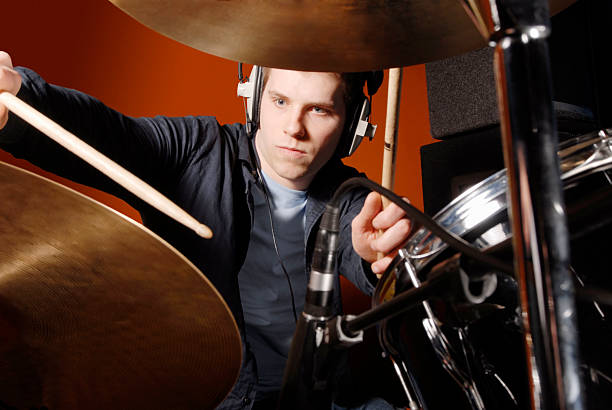 istock Male drummer with 2 drum sticks behind drum kit 182689539