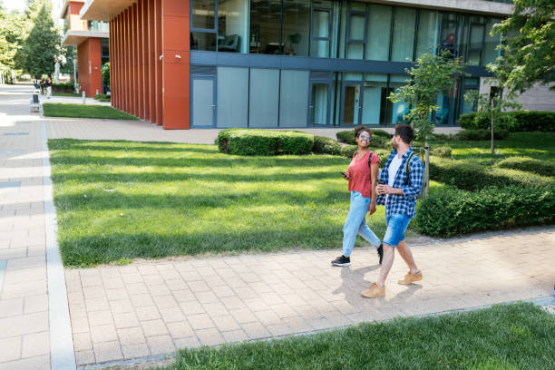 istock Wide angle shot of multi ethnic young people walking in modern district 1826898357
