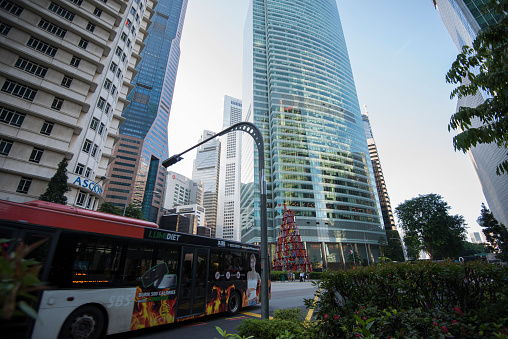 Singapore City, Singapore - September 08, 2019: Low wide-angle view looking up to modern skyscrapers in business district of Singapore City.