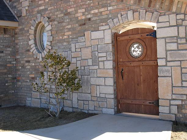 Wood Gate in stone and brick wall stock photo