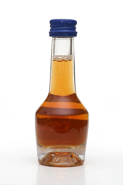 istock Small bottle of liquor, isolated on white 182690122