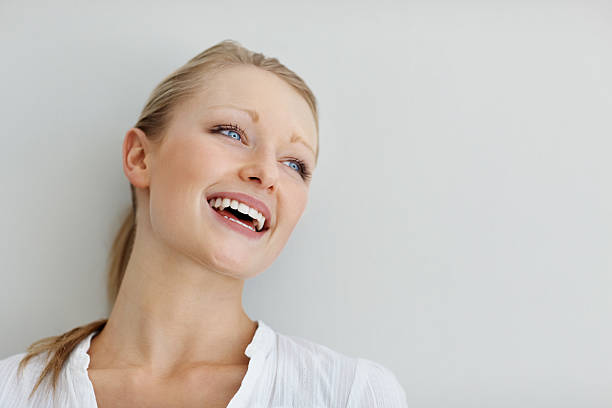 istock Teenage female laughing isolated against plain background 182690654