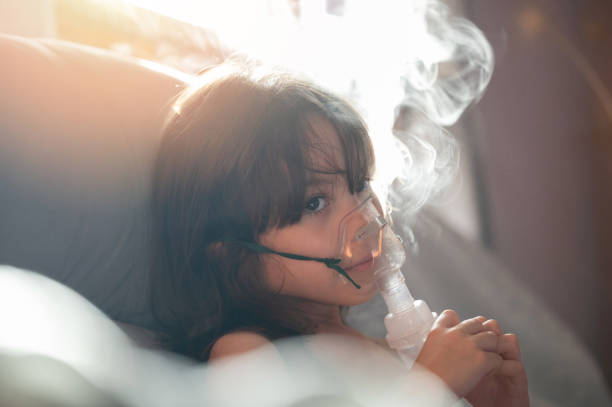 istock Kid girl with neubilizer at home 1826907780