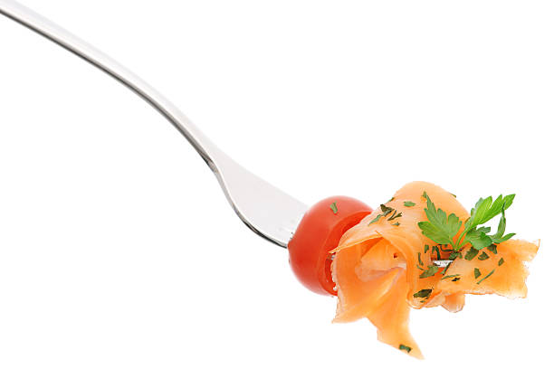 istock Smoked salmon tomato and parsley on fork isolated 182691013