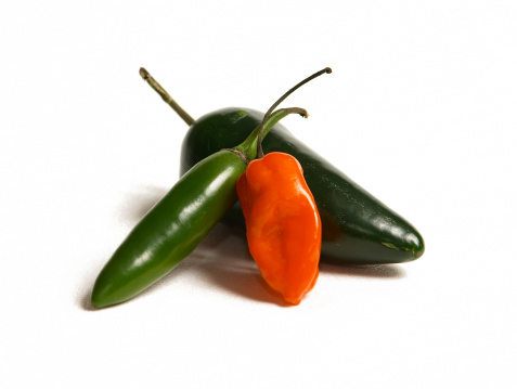 Three hot peppers on white