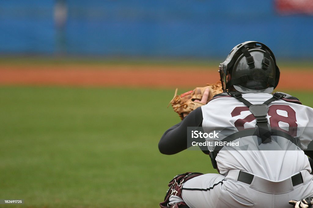 Catcher at a baseball game in position to catch a catcher in a baseball game Baseball - Sport Stock Photo