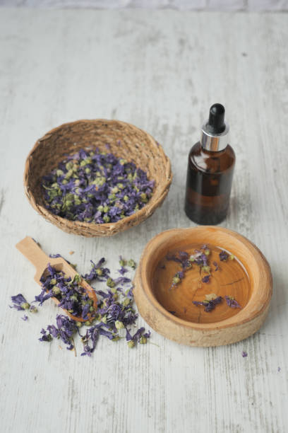 istock Essential lavender oil and flowers on table with copy space 1826920793