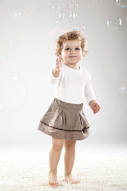 istock Baby girl reaching for bubble 182692099
