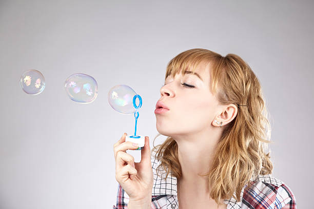 istock Woman blowing a bubble 182692291