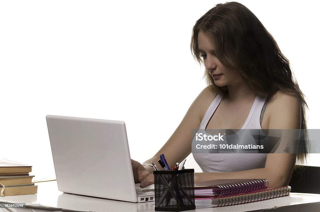 Teenage girl with laptop Teenage girl working on the laptop isolated white backround Adult Stock Photo