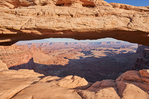Mesa arch is a 27 foot long pothole arch that frames a beautiful view of the outstretched canyon below. Located in Canyonlands National park, this landmark is a very popular overlook