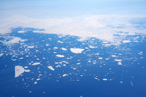 aerial image of glacier floating ice on sea - climate change and global warming.