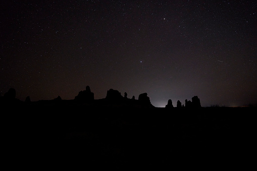 A beautiful night sky over some moonlike alien rock formations, that are very unique.