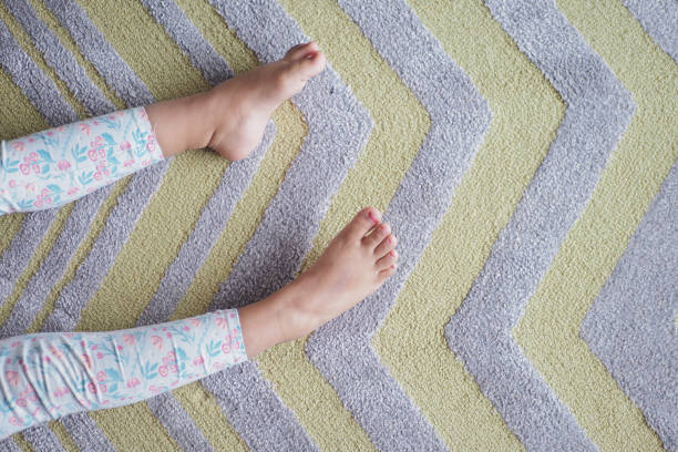 istock top view of child bare feet on a carpet 1826935712