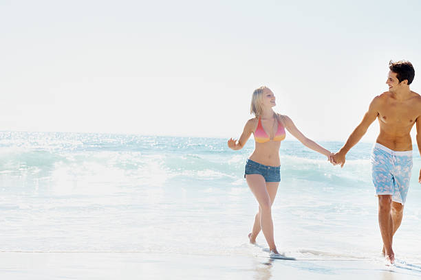istock Summer vacation - Romantic couple holding hands on the beach 182693923