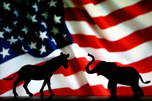 Democrats VS Republicans Silhouette of a Donkey and an Elephant in front of an American Flag. us republican party photos stock pictures, royalty-free photos & images