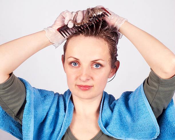istock Woman coloring hair 182694575