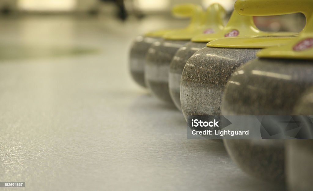 curling rocks and ice curling rocks lined up on ice Curling - Sport Stock Photo