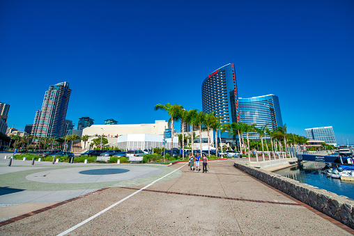 Tourists, streets and buildings along Seaport Village and Embarcadero Park