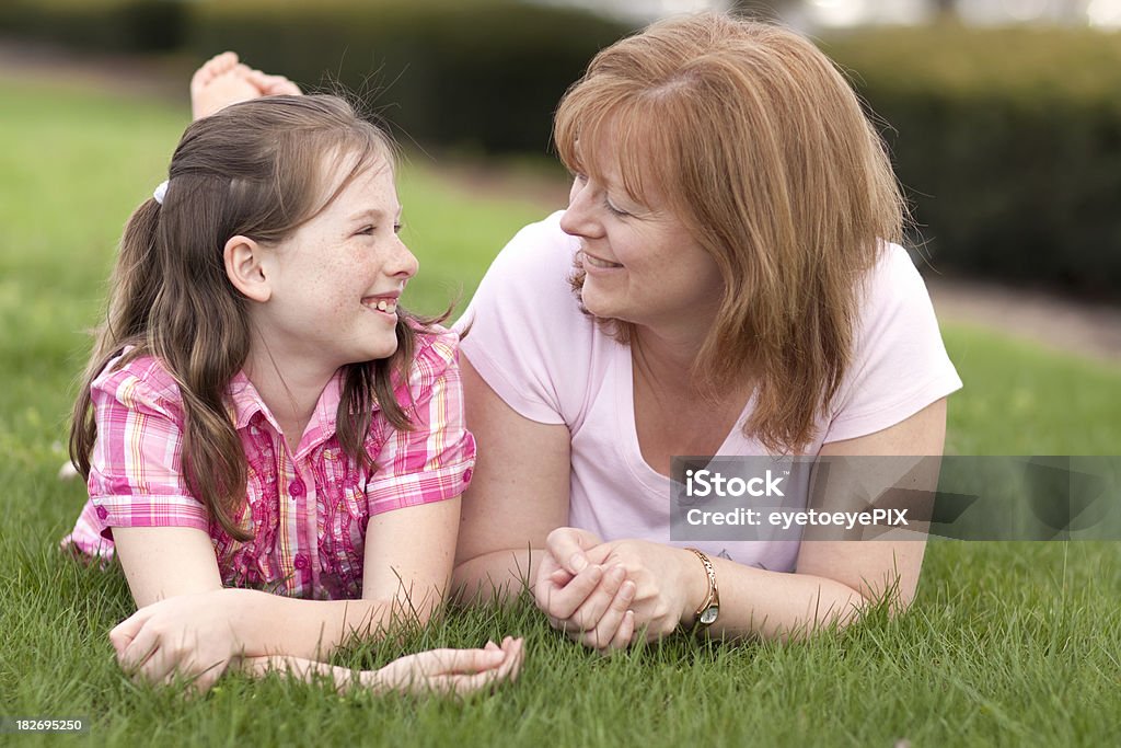 Mother and daughter smiling on grass (Series) Mother and daughter smiling on grass Adult Stock Photo