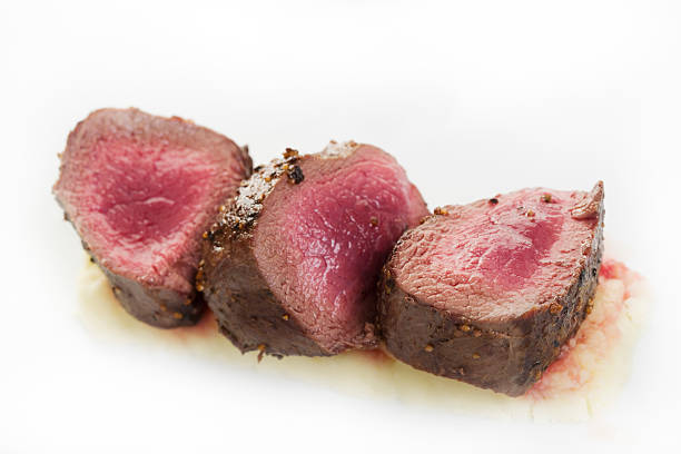 Very raw looking venison steak stock photo