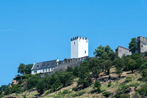 View from the river Rhine at Sterrenberg castle on the top of a hill near the village of Kamp-Bornhofen.