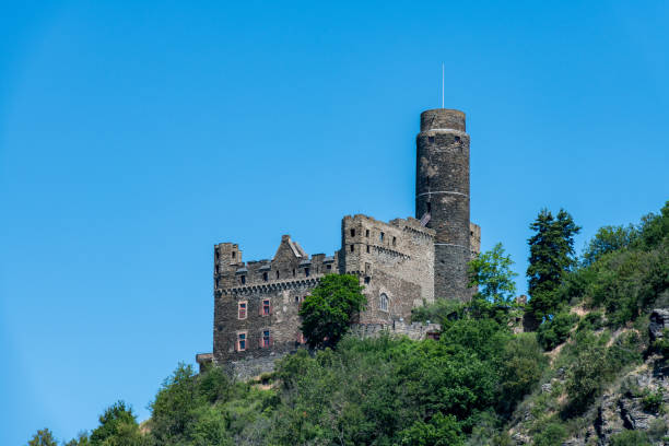 View from the river Rhine at the medieval castle Maus (Mouse) on the top of a hill near the small village of Welmich.
