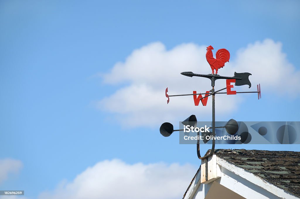 Weather vane and anemometer. Traditional weather vane with cockrell motif and anemometer with blue sky and cloud background for copy. Anemometer Stock Photo