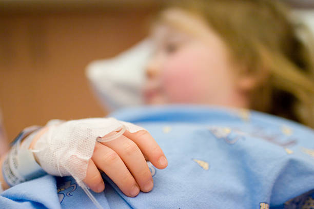 Little child, tied to the hospital bed stock photo