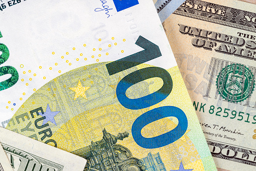 American dollars and European euros close-up, different convertible currencies of euros and dollars together