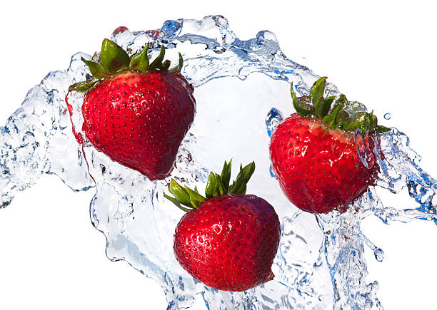 istock Fresh Fruit, Three Red Strawberries Tossed in Water, White Background 182696777