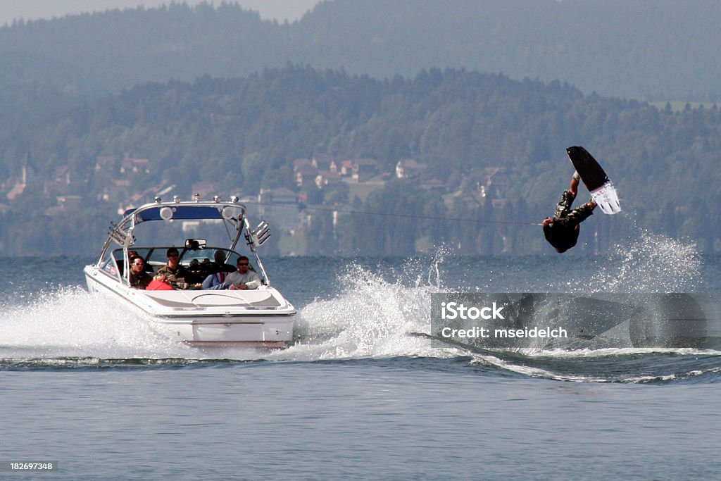 A wakeboarder in the water being pulled by a boat Swiss Wakeboard Championships 2005 Nautical Vessel Stock Photo