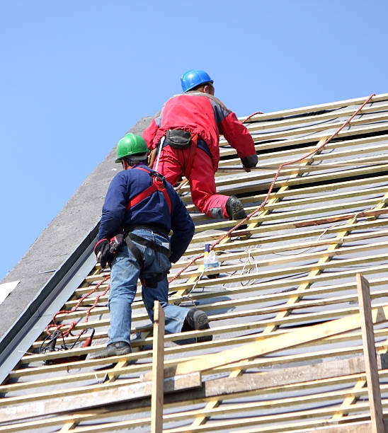 istock two roofers are working on the roof 182697483