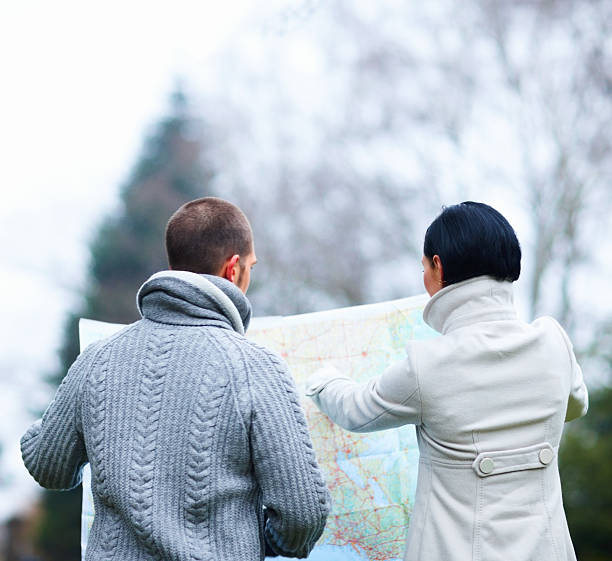 istock Winter couple studying a map outdoors 182697536