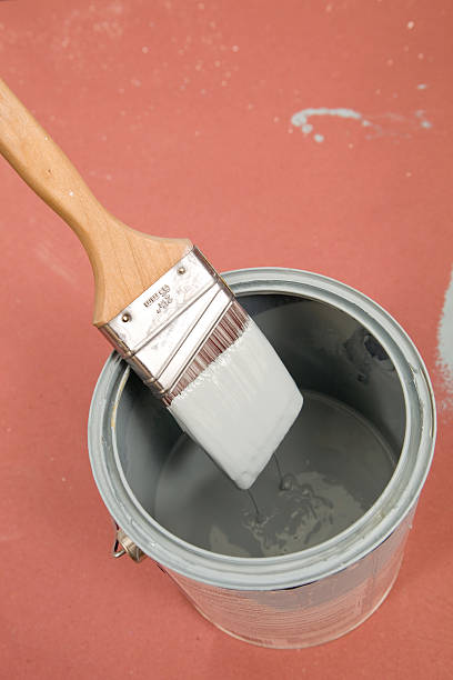 istock Paintbrush Dripping Paint into Bucket 182697984