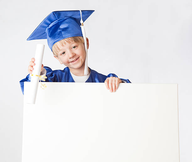 istock Little Graduate Holding a Sign and Diploma 182698041